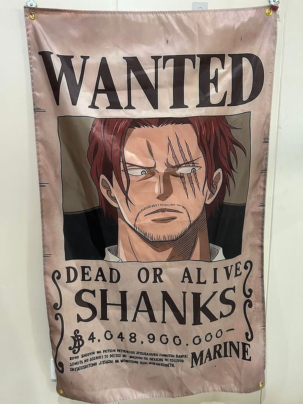 Shanks wanted poster flag hanging on a wall with corner grommets